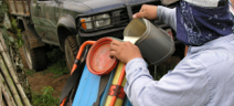 A farm worker fills a backpack sprayer with pesticides, south of Cipreses, Cartago Province, Costa Rica